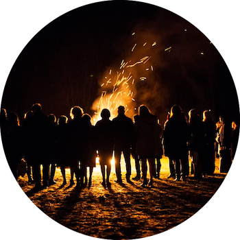 group of people standing by fire