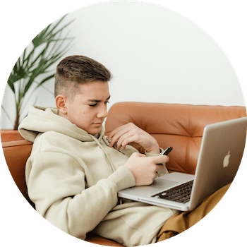teenage boy on sofa doing online therapy session