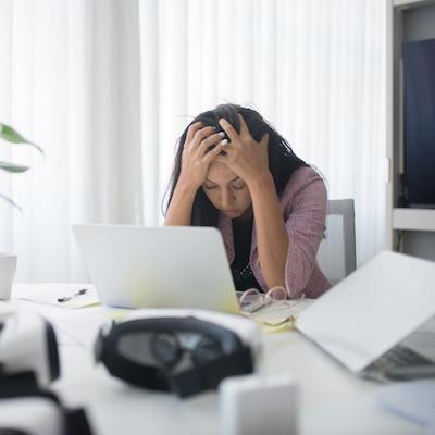 woman looking stressed at desk